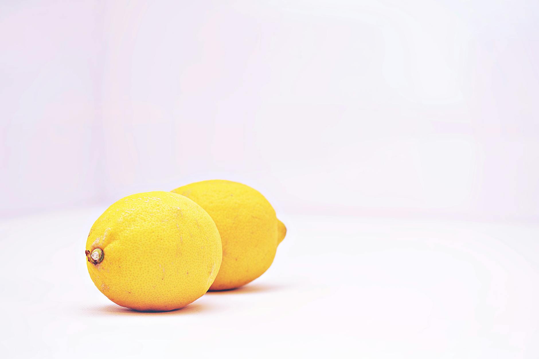 Fresh lemons on a white background, symbolizing the tart, bright nature of clitoral sensation changes.