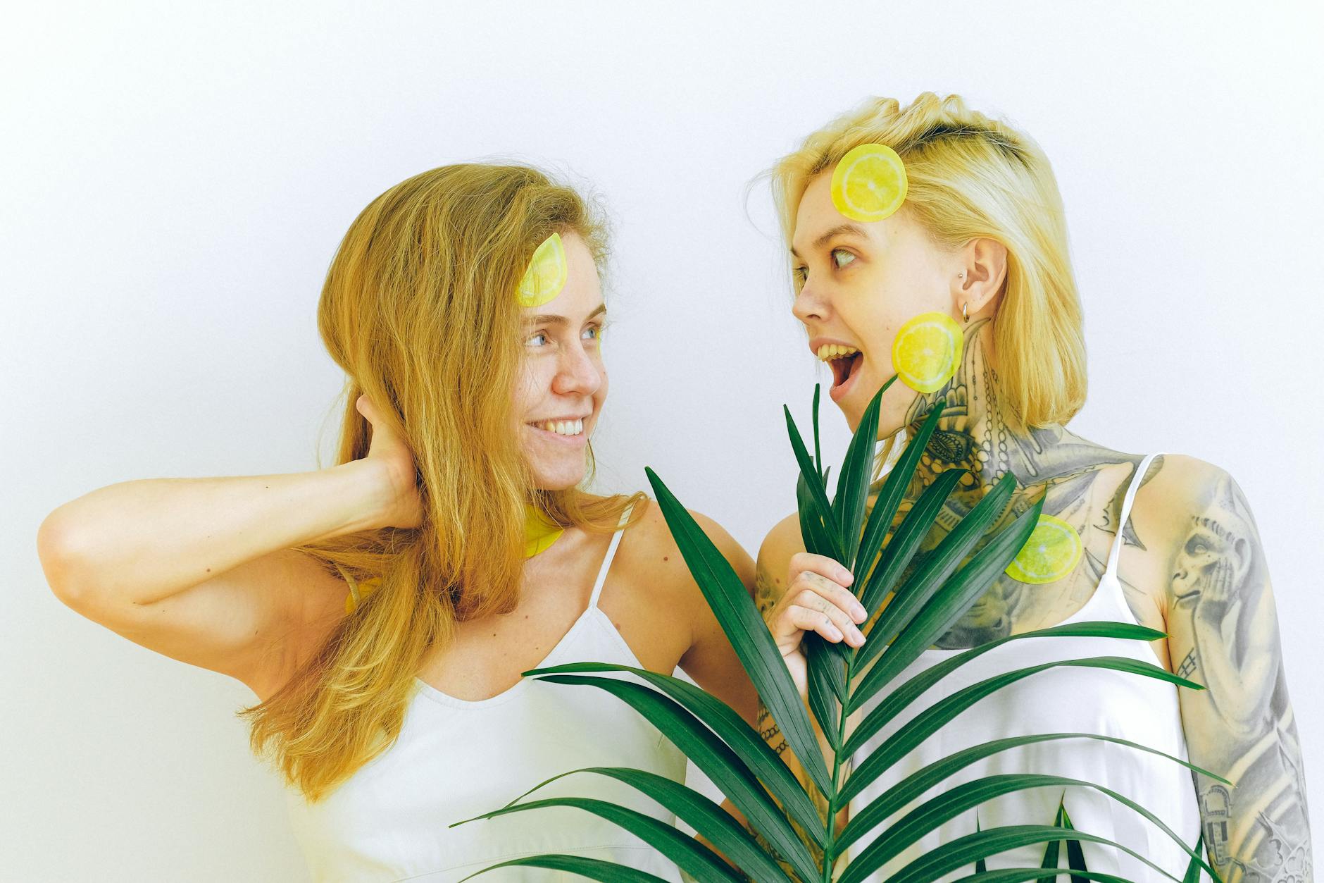 Two women smiling together, expressing joy and comfort in conversation indoors