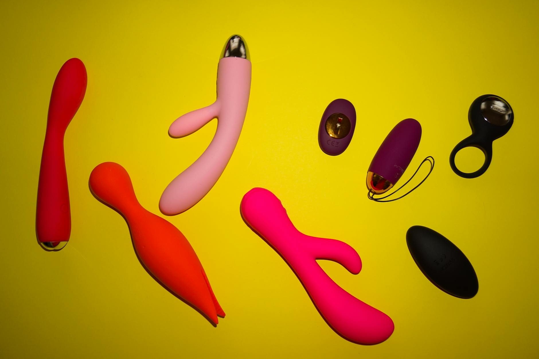 Hands holding a blue vibrator against a purple background, representing intimate self-paced pleasure